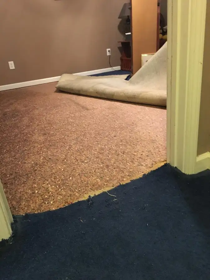 Carpet pad removal revealing water damage during Water Mitigation Services in South San Jose Hills